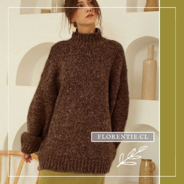 Vista frontal del chaleco café oscuro oversize con cuello tortuga alto, tejido grueso esponjoso en tono chocolate y mangas amplias con puños acanalados, combinado con falda verde oliva.